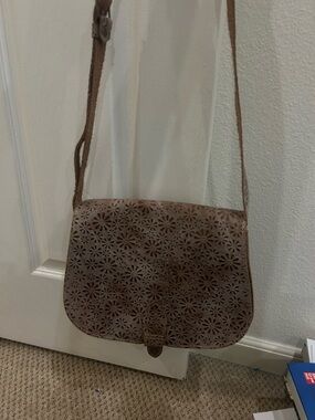 brown leather crossbody bag with floral design